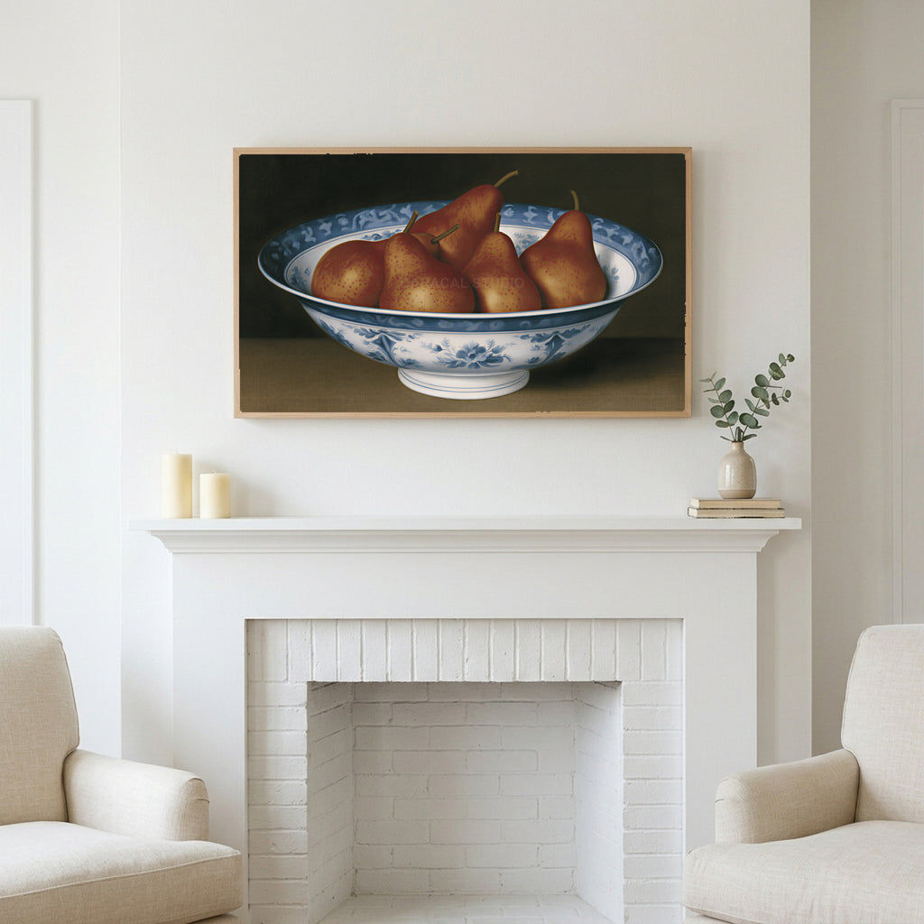 Pears in a porcelain bowl art above a white fireplace with candles and eucalyptus on the mantel