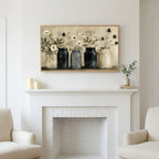 Farmhouse flower jars art above a white fireplace with candles and eucalyptus on the mantel