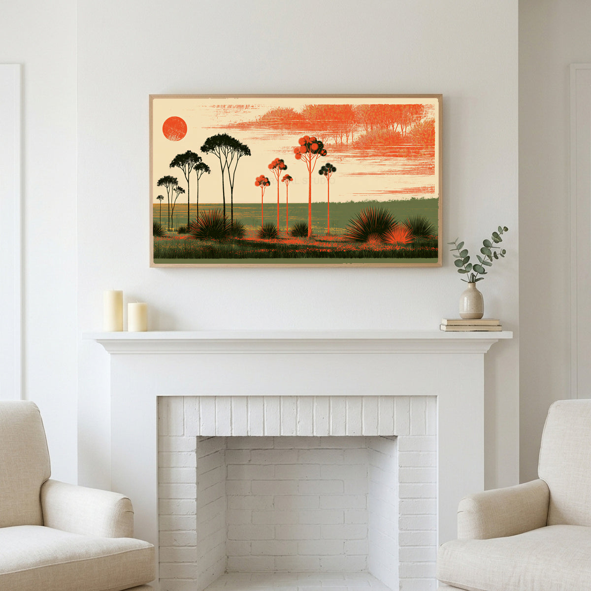 Block print trees art above a white fireplace with candles and eucalyptus on the mantel