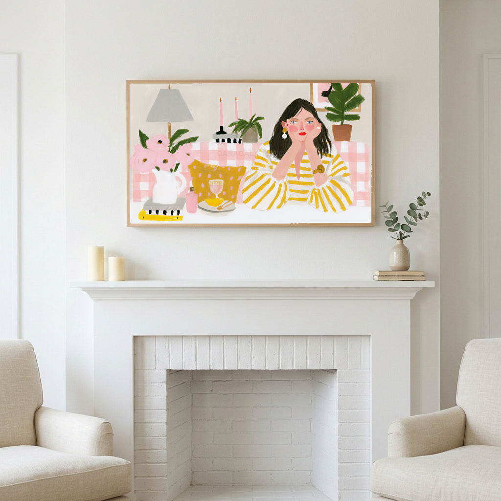Frame TV art above a white fireplace with candles and eucalyptus on the mantel