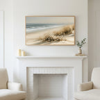 Dune grass and daisies art above a white fireplace with candles and eucalyptus on the mantel
