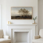 Birch trees landscape art above a white fireplace with candles and eucalyptus on the mantel