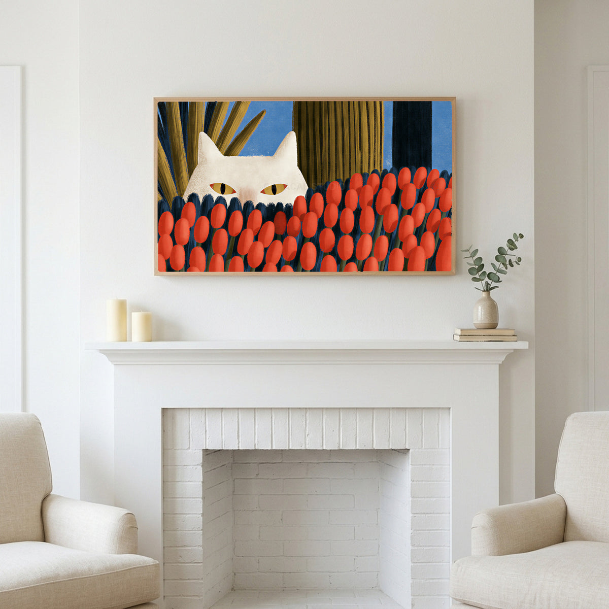 White cat and red tulips art above a white fireplace with candles and eucalyptus on the mantel