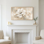 White flower art above a white fireplace with candles and eucalyptus on the mantel
