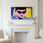 Pop art woman in sunglasses art above a white fireplace with candles and eucalyptus on the mantel