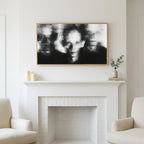Blurred faces art above a white fireplace with candles and eucalyptus on the mantel