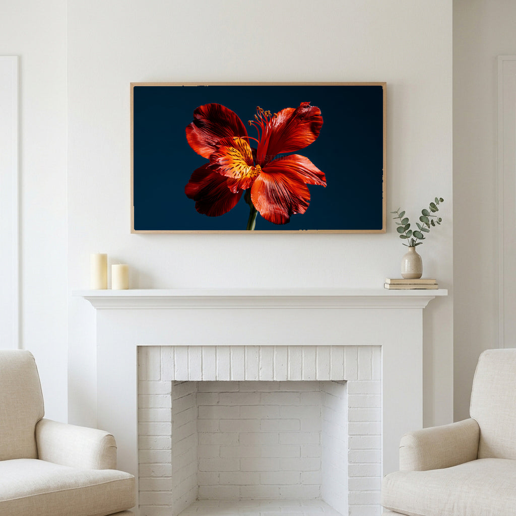 Red lily on navy art above a white fireplace with candles and eucalyptus on the mantel