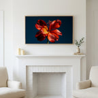 Red lily on navy art above a white fireplace with candles and eucalyptus on the mantel