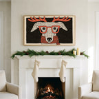 Whippet with reindeer antlers art on a TV above a white fireplace with a pine garland and cream stockings