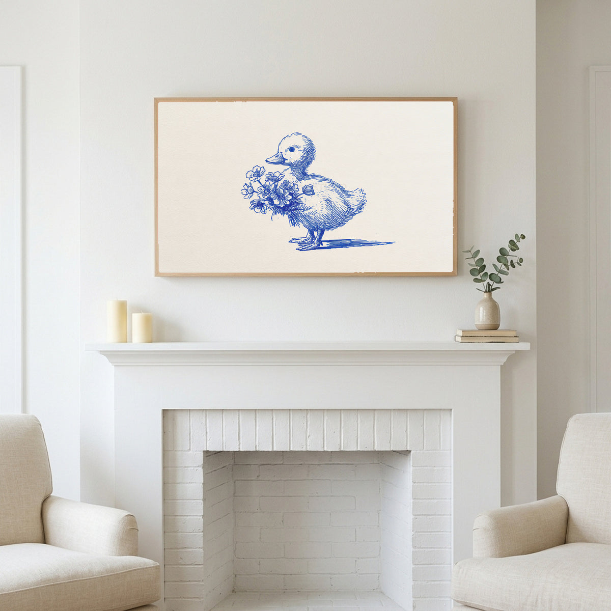 Duckling art above a white fireplace with candles and eucalyptus on the mantel