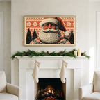 Santa portrait art on a TV above a white fireplace with a pine garland and cream stockings