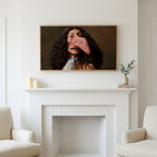 Funny baroque portrait art above a white fireplace with candles and eucalyptus on the mantel