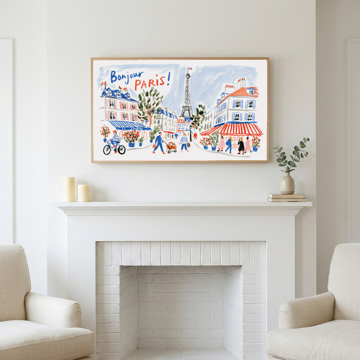 Bonjour Paris art above a white fireplace with candles and eucalyptus on the mantel
