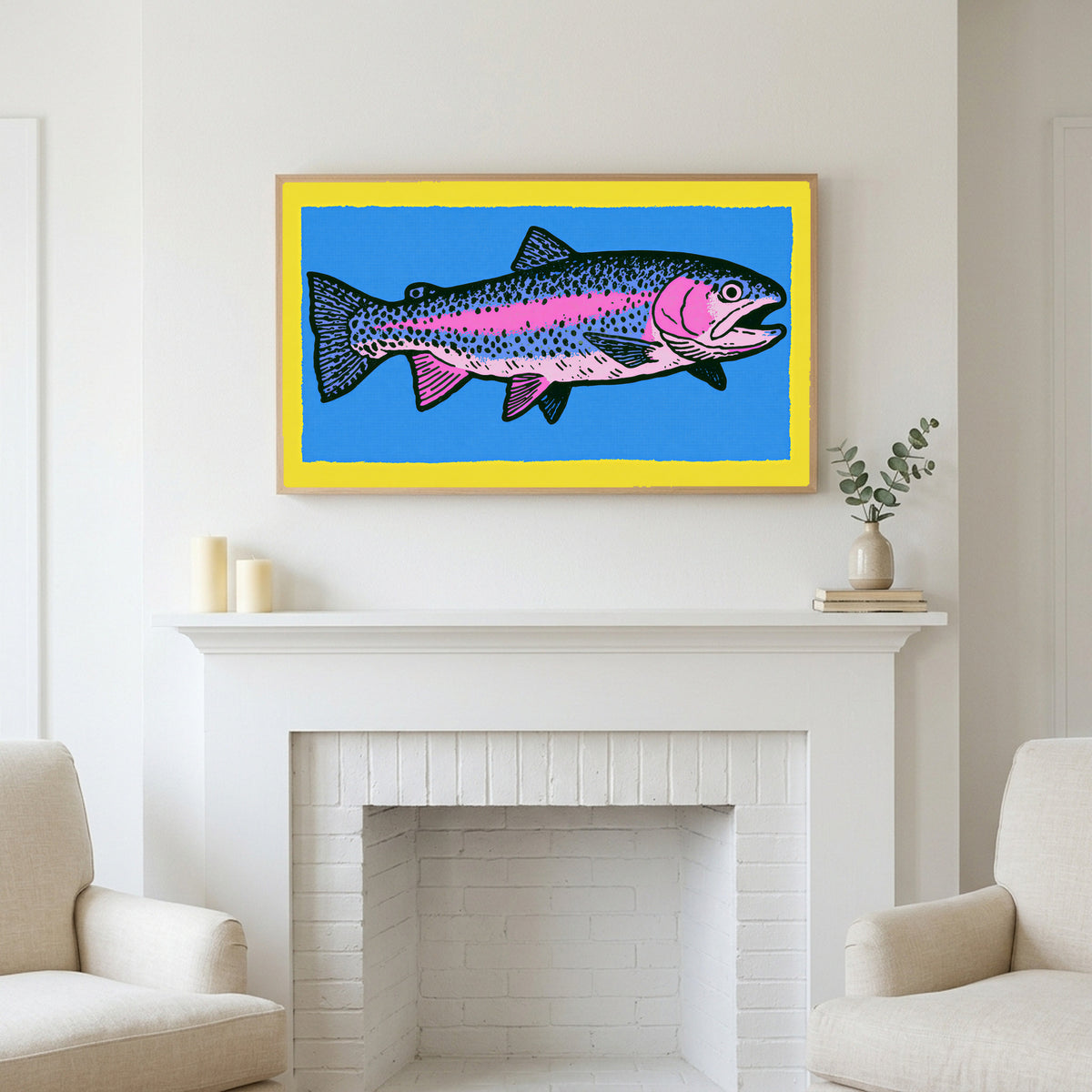 Rainbow trout art above a white fireplace with candles and eucalyptus on the mantel