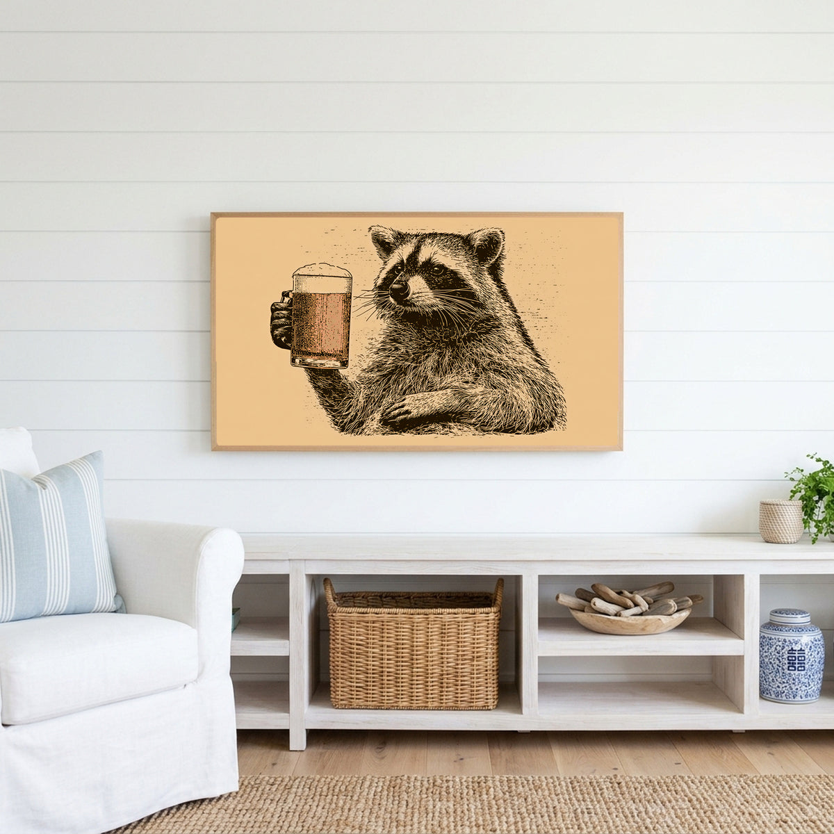 Beer raccoon Frame TV art above a white console with a rattan basket in a coastal living room