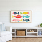 Linocut fish Frame TV art above a white console with a rattan basket in a coastal living room