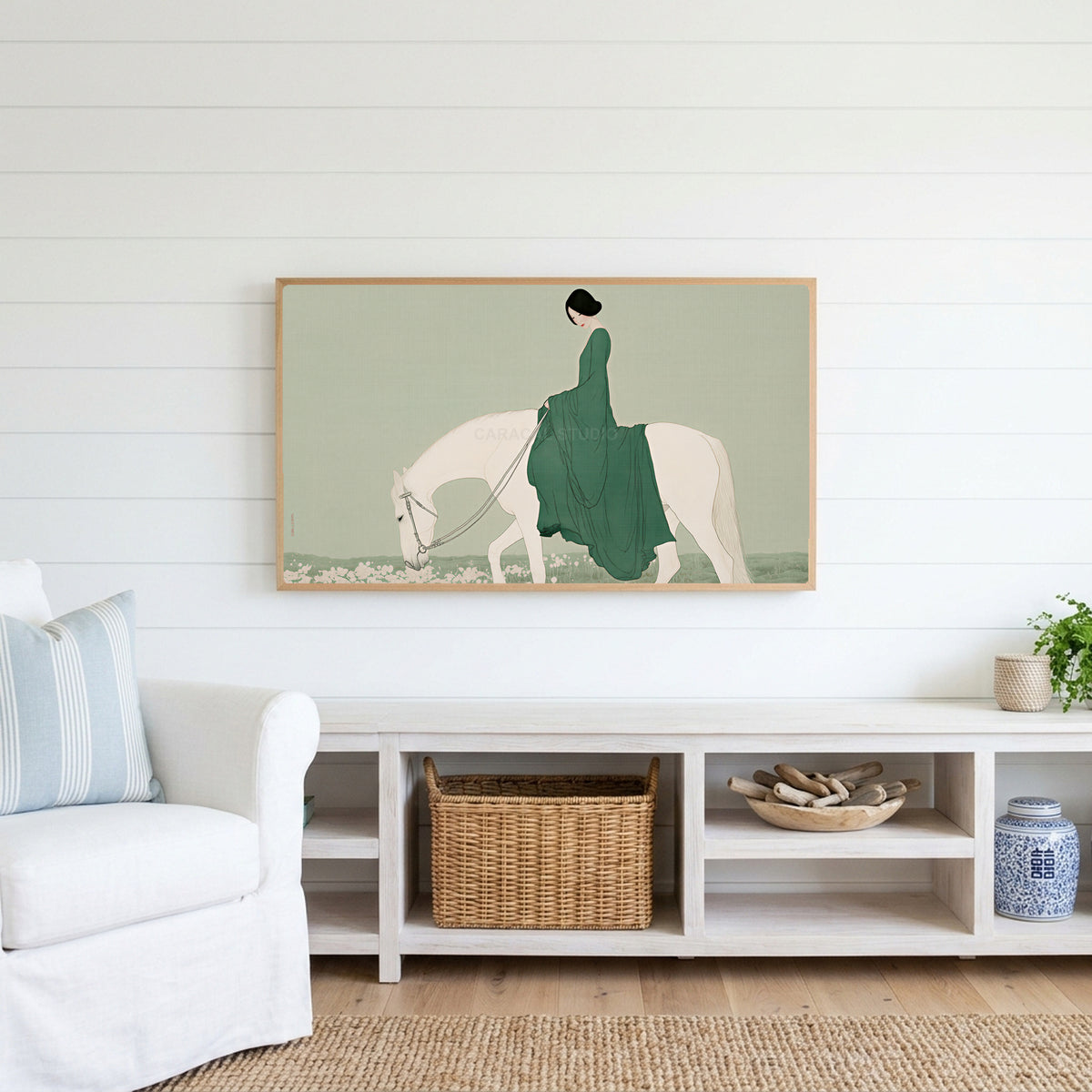 Woman riding a horse Frame TV art above a white console with a rattan basket in a coastal living room