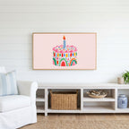 Rainbow birthday cake Frame TV art above a white console with a rattan basket in a coastal living room