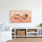 Party table still life Frame TV art above a white console with a rattan basket in a coastal living room
