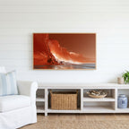 Red sea cliffs Frame TV art above a white console with a rattan basket in a coastal living room