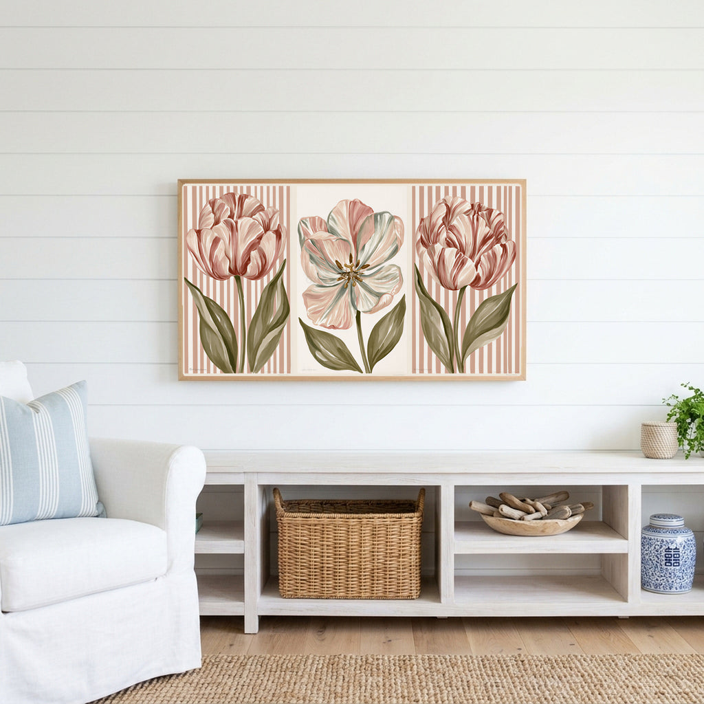 Tulip trio Frame TV art above a white console with a rattan basket in a coastal living room