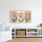 Tulip trio Frame TV art above a white console with a rattan basket in a coastal living room