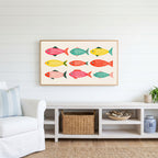 Folk fish Frame TV art above a white console with a rattan basket in a coastal living room