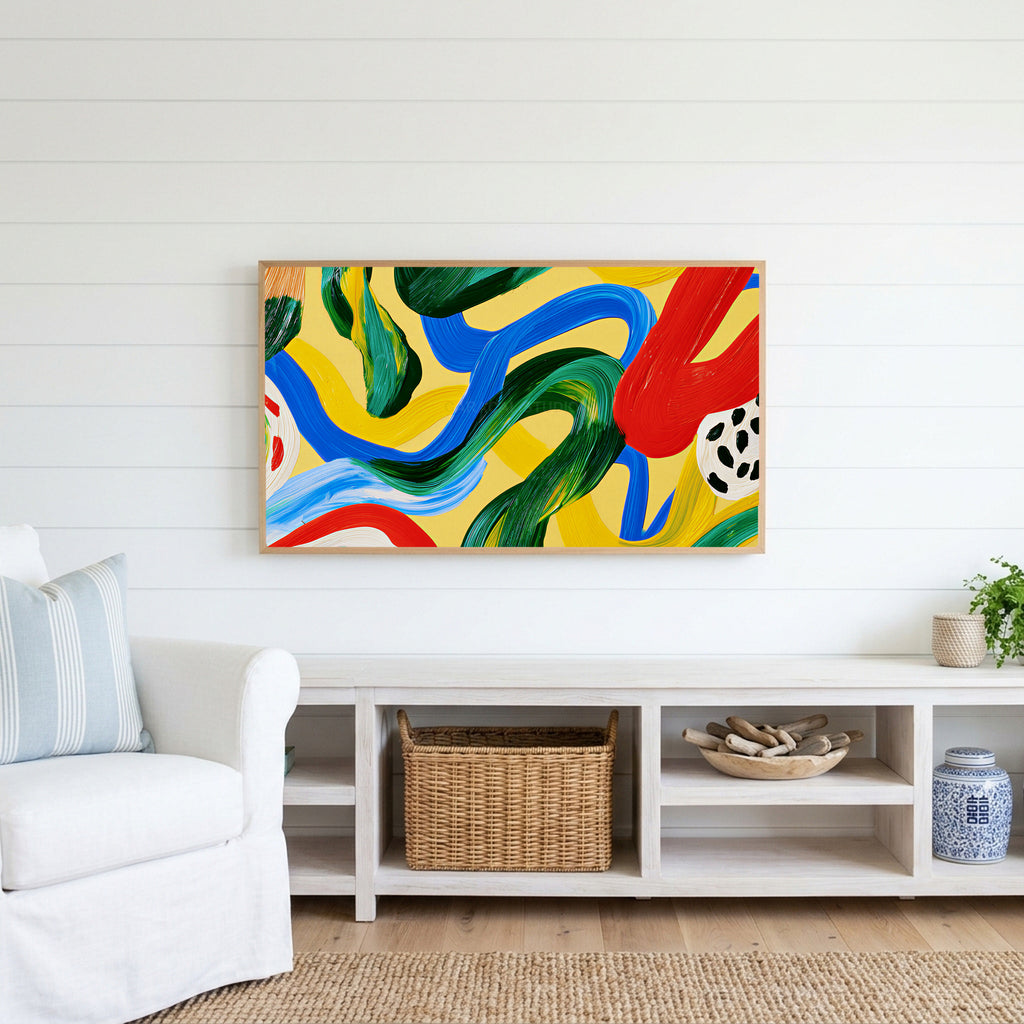 Colorful brushstroke loops Frame TV art above a white console with a rattan basket in a coastal living room