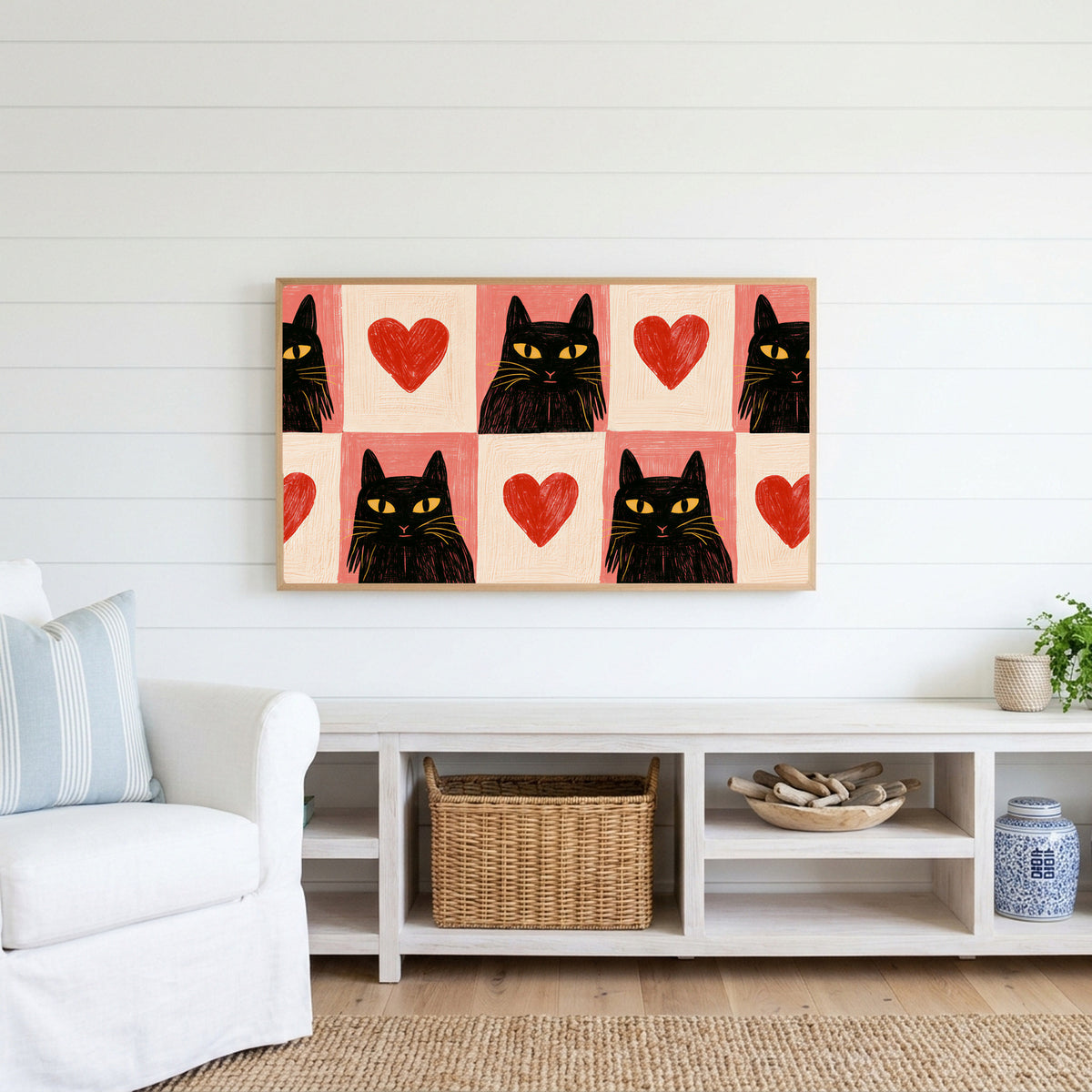 Black cat and heart Frame TV art above a white console with a rattan basket in a coastal living room