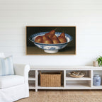 Pears in a porcelain bowl Frame TV art above a white console with a rattan basket in a coastal living room