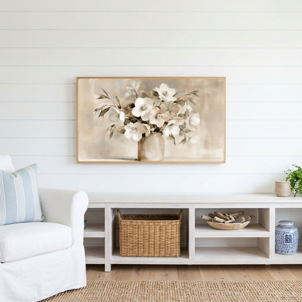 White hellebores Frame TV art above a white console with a rattan basket in a coastal living room
