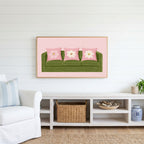 Green sofa Frame TV art above a white console with a rattan basket in a coastal living room