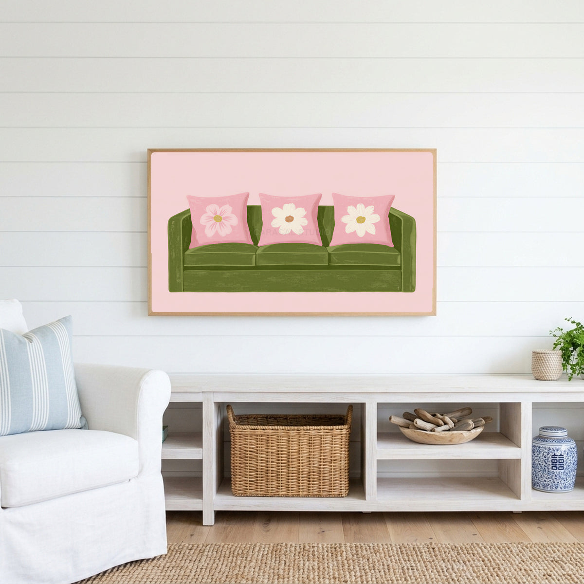 Green sofa Frame TV art above a white console with a rattan basket in a coastal living room