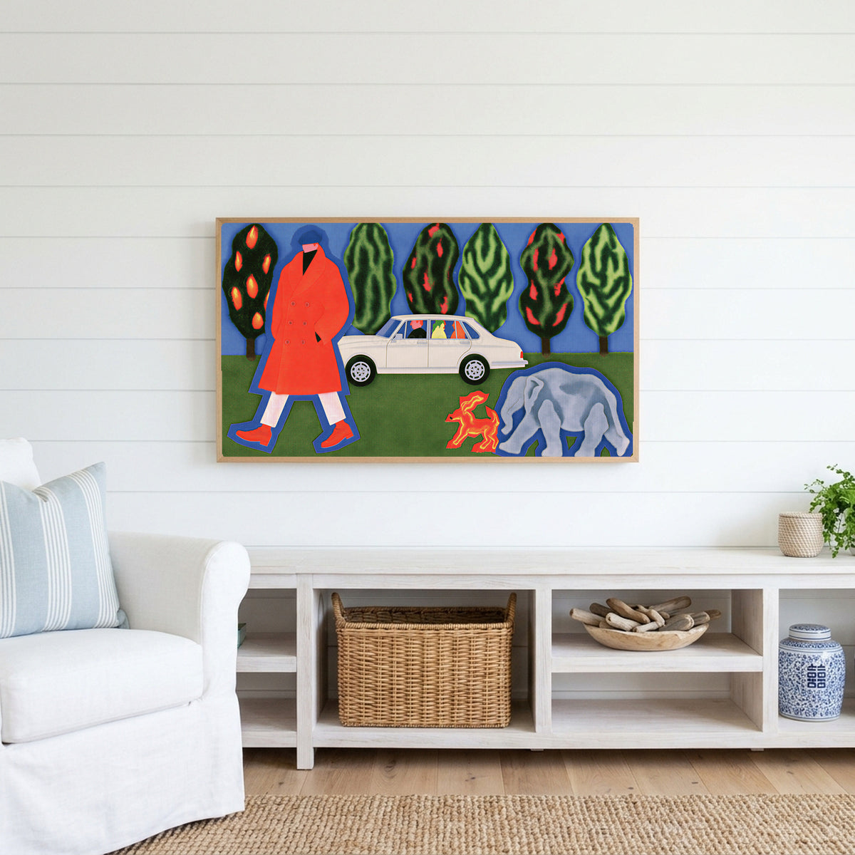Surreal red coat collage Frame TV art above a white console with a rattan basket in a coastal living room