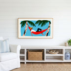 Hammock Frame TV art above a white console with a rattan basket in a coastal living room