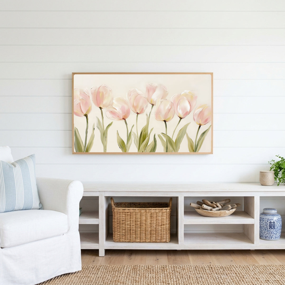 Pink tulip Frame TV art above a white console with a rattan basket in a coastal living room