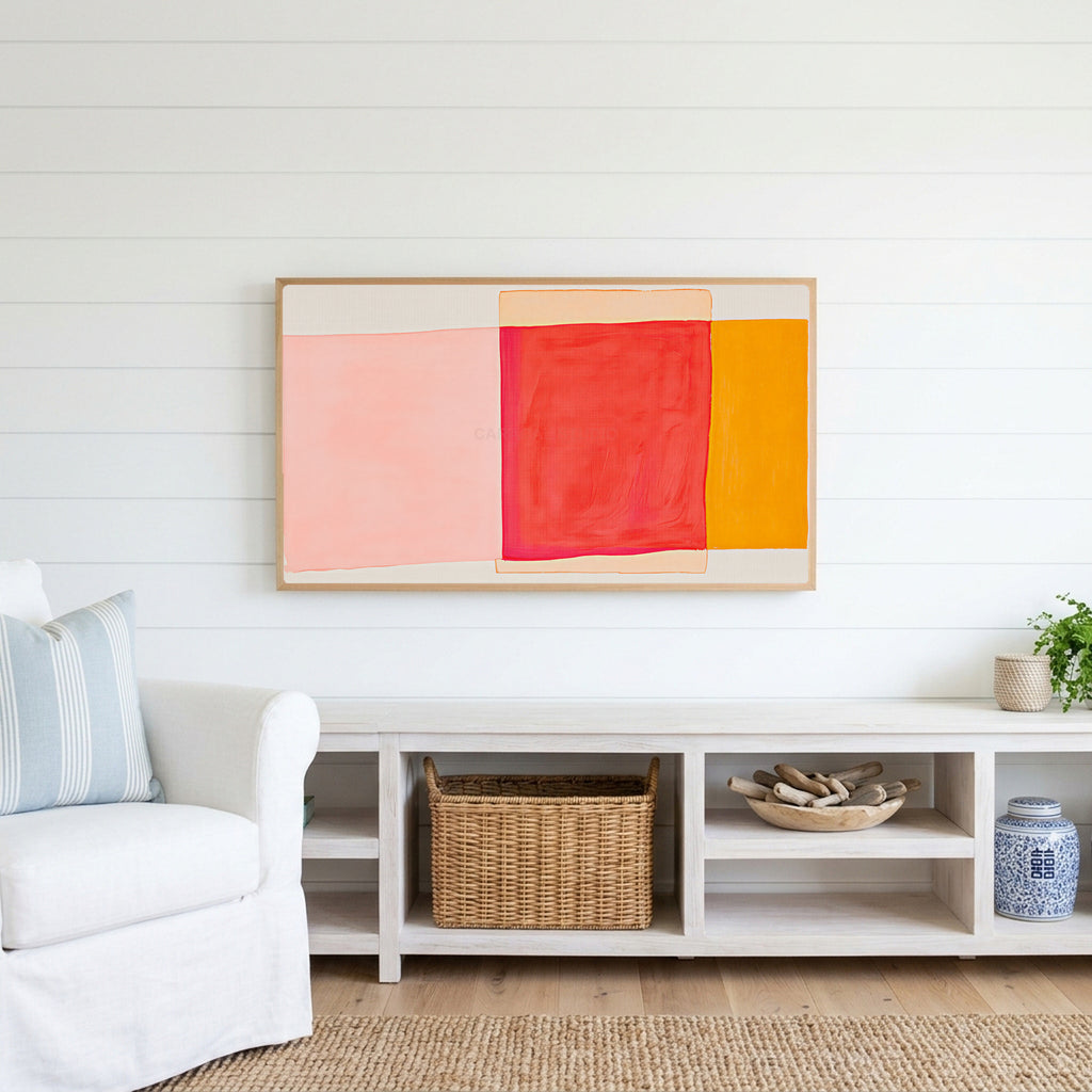 Abstract color blocks Frame TV art above a white console with a rattan basket in a coastal living room
