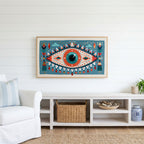 Folk art mystic eye Frame TV art above a white console with a rattan basket in a coastal living room