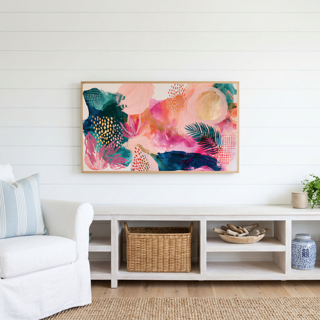 Tropical abstract Frame TV art above a white console with a rattan basket in a coastal living room