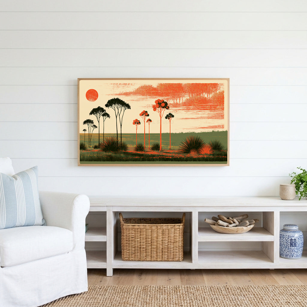 Block print trees Frame TV art above a white console with a rattan basket in a coastal living room