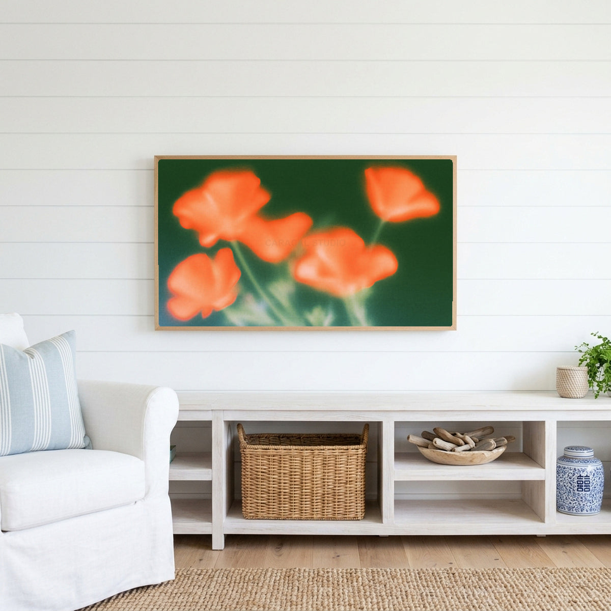 Blurred orange poppies Frame TV art above a white console with a rattan basket in a coastal living room