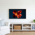 Red lily on navy Frame TV art above a white console with a rattan basket in a coastal living room