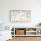 Cherry blossom tree Frame TV art above a white console with a rattan basket in a coastal living room