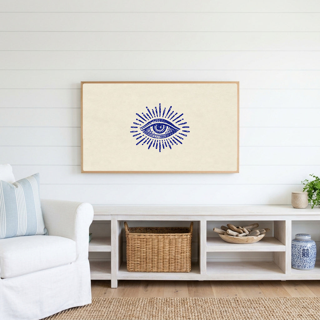 Mystic eye Frame TV art above a white console with a rattan basket in a coastal living room
