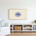 Mystic eye Frame TV art above a white console with a rattan basket in a coastal living room
