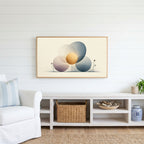 Abstract circles Frame TV art above a white console with a rattan basket in a coastal living room