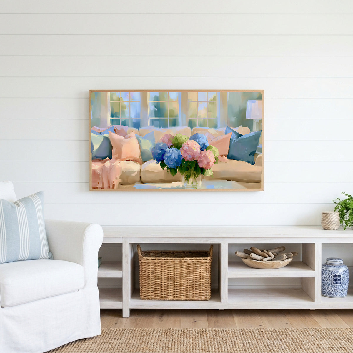 Pastel hydrangea bouquet Frame TV art above a white console with a rattan basket in a coastal living room