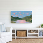 Flying fish Frame TV art above a white console with a rattan basket in a coastal living room