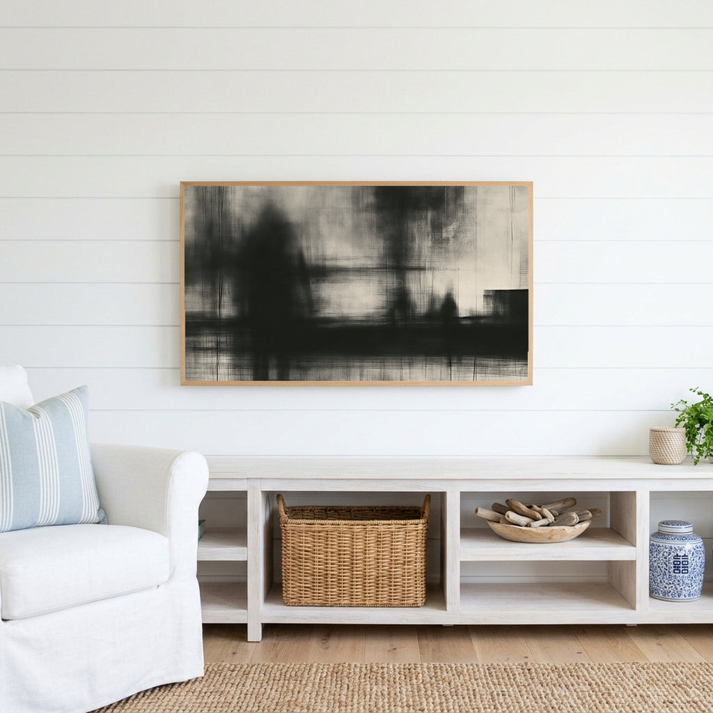 Black and white abstract Frame TV art above a white console with a rattan basket in a coastal living room