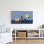 Retro desk, radio and clock Frame TV art above a white console with a rattan basket in a coastal living room